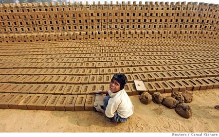 A boy works in a brick factory.
