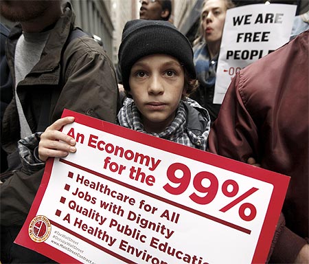 An Occupy Wall Street demonstrator holds a sign during what protest organizers call a Day of Action in New York.