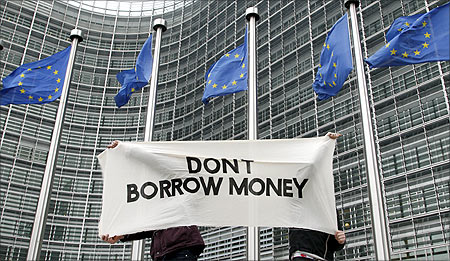 Students display a banner outside the EU Commission headquarters ahead of an European Union summit in Brussels.