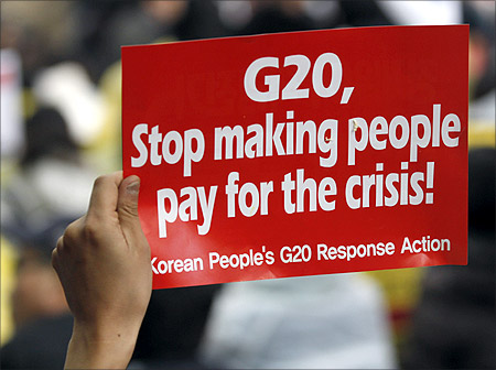 A demonstrator holds up a sign during an anti G20 protest in downtown Seoul.