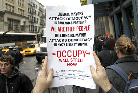 An Occupy Wall Street demonstrator holds up a sign during what protest organizers called a Day of Action in New York.