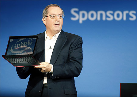 Paul Otellini, president and CEO of Intel Corporation, holds an ultrabook.