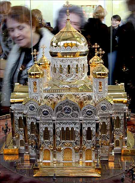A visitor looks at a copy of Moscow's Christ the Saviour Cathedral made of gold, silver and precious stones at an exhibition in St Petersburg.