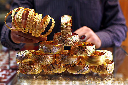 A goldsmith displays gold bangles in his jewellery shop in Istanbul.