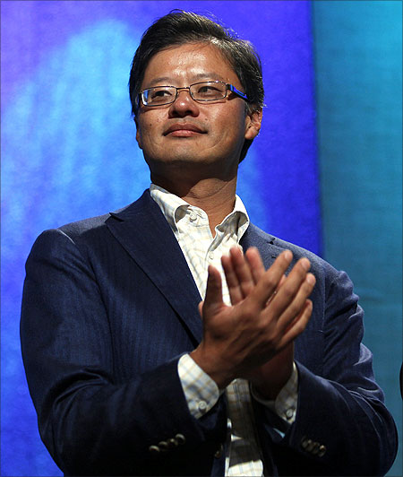 Jerry Yang applauds during the announcement of a commitment pledge at the Clinton Global Initiative in New York.