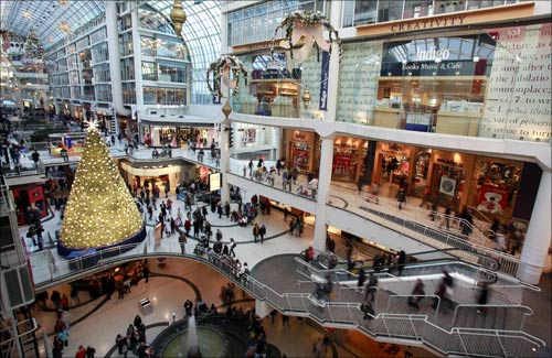 A Christmas tree is seen in the midst of shoppers in a major downtown shopping mall in Toronto.