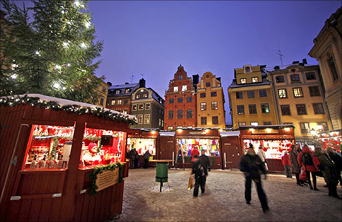 Visitors walk through the Christmas market in Stockholm's Gamla Stan district.