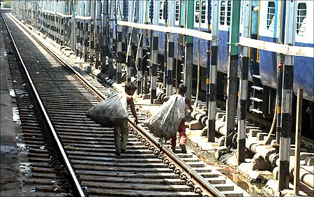 Rag pickers walk along a railway track at the railway station in the northern Indian city of Allahabad.