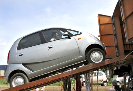 A Tata Motors Nano car is loaded onto a goods train for shipment at Sanand railway station.