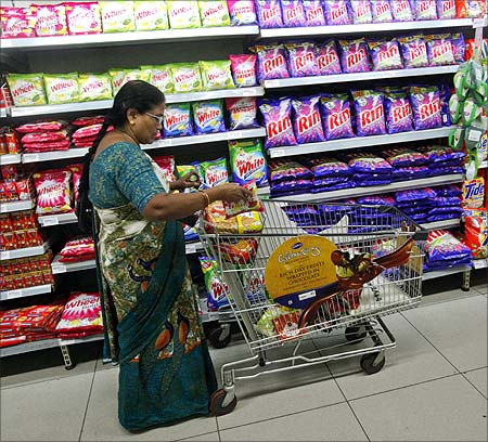An Indian woman fills her trolley with retail products as she shops at a Hypercity department store.