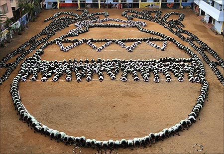 Children arrange themselves into a formation of the Pongal Panai, or an earthen pot, as part of the Pongal festival celebrations in Chennai.