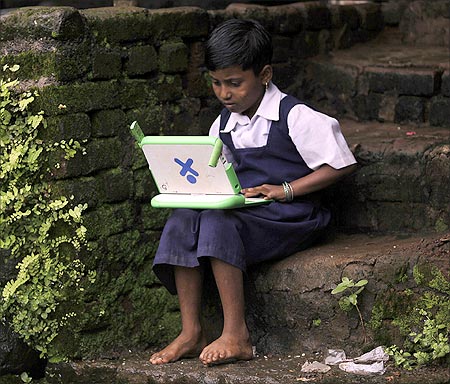 A school girl uses a laptop.