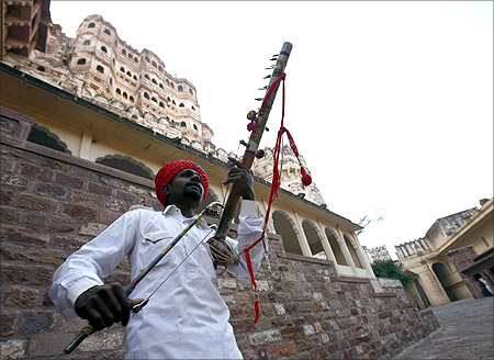 A Rajasthani artisan plays music at the entrance of the Meharangarh Fort in the historic town of Jodhpur.