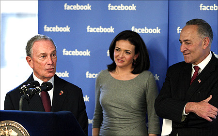 New York City Mayor Michael Bloomberg speaks to the media while Facebook's Chief Operating Officer (COO) Sheryl Sandberg and U.S. Senator Charles Schumer (L-R).