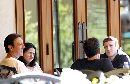 ESPN President George Bodenheimer, Sheryl Sandberg, Walt Disney Company CEO Robert Iger and Facebook CEO Mark Zuckerberg (L-R) talk at the Sun Valley Inn.