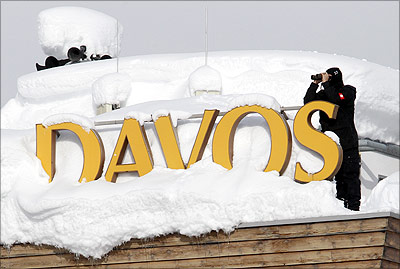 A member of Swiss special police forces observes from the roof of a hotel covered in snow in Davos.