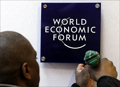 -A worker sets a logo of the World Economic Forum.