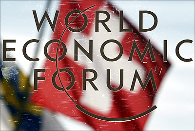 Switzerland's national flag is reflected in a sign for the World Economic Forum in Davos.