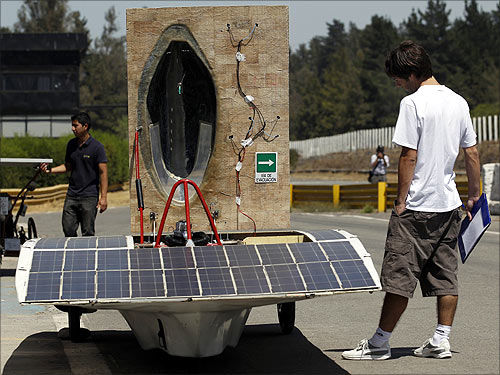 A man looks at a solar car during a promotional launch of the Atacama Solar Race 2012 in Santiago.