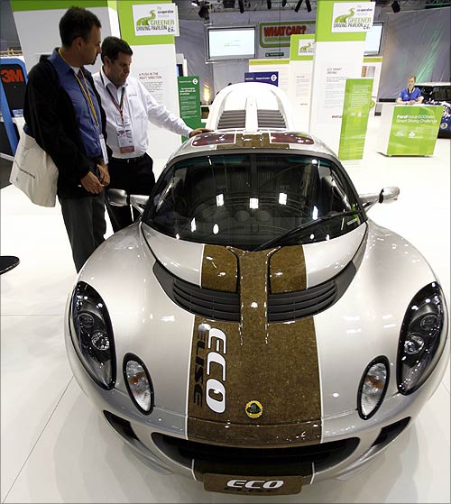 Visitors to the British International Motorshow in London's Excel centre look at a Lotus Eco.