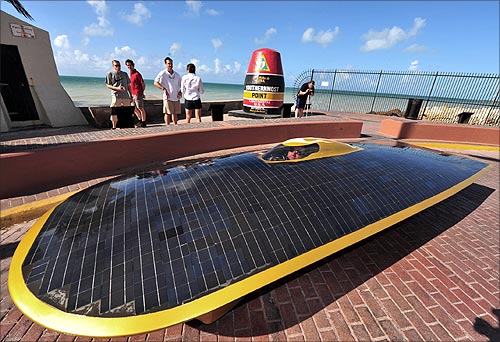 Marcelo da Luz drives his solar car by the Southernmost Point in the Continental U.S. marker in Key West, Florida.