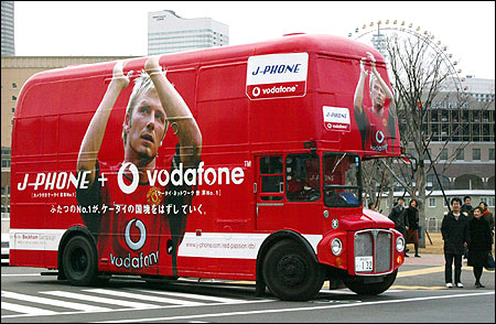 A double-decker bus with an advertisement featuring David Beckham runs in Yokohama,  on December 22, 2002.