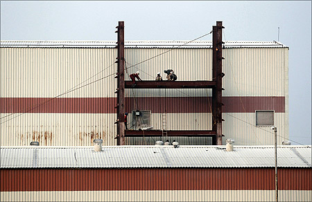 Labourers work at a factory under construction at Hajipur industrial park on the outskirts of Patna.