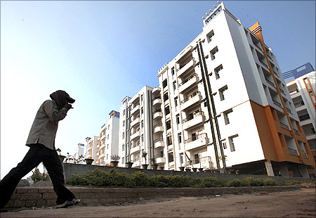 A labourer walks past residential apartments in Patna.