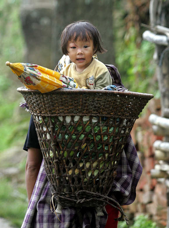 A woman carries her daughter in Khonoma village, on the outskirts of Kohima, capital of Nagaland.