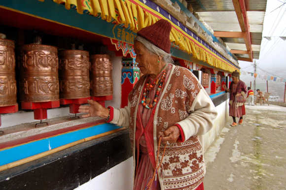 An elderly lady of the Manpa tribe spins prayer wheels at a monastery in Tawang, in Arunachal Pradesh, near the border with China.