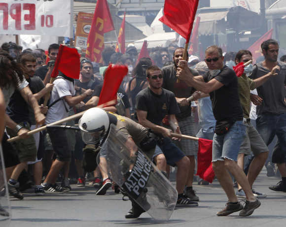 Protesters beat a riot policeman during a rally against government austerity measures in Athens.