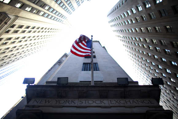 Flag flies at exterior of New York Stock Exchange.