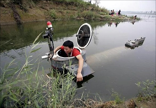Tao Xiangli gets out of his homemade submarine after operating it in a lake on the outskirts of Beijing.