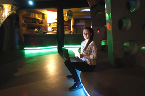 Daria Vitasovic, a 27 year-old bar manager, poses for a picture as she works on her laptop in a night bar in Zagreb.