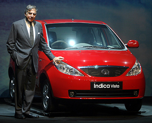 Tata Motors Chairman Ratan Tata poses with the company's new Indica Vista car during its launch in Mumbai.