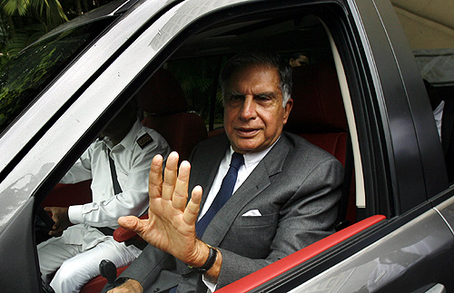 Tata Motors Chairman Ratan Tata waves as he leaves after addressing a news conference.