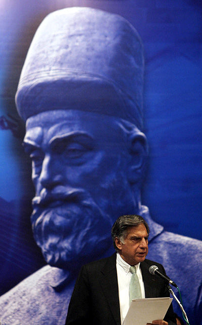 Ratan Tata speaks in front of a portrait of Tata Group founder Jamsetji Nusserwanji Tata.