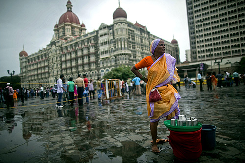 A woman sells drinking water near the Taj Mahal hotel in Mumbai.