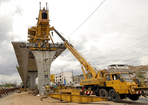 Labourers work at a flyover undergoing construction in Hyderabad.