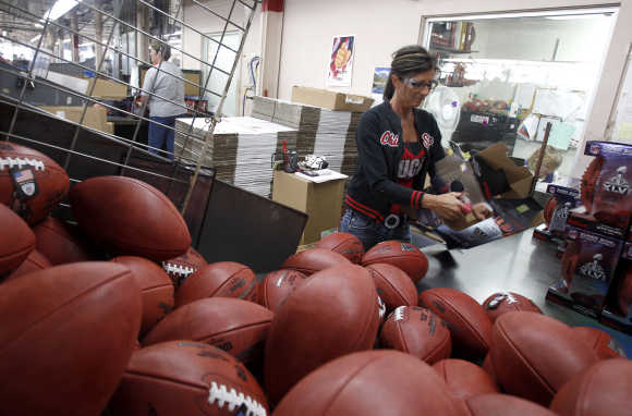 A woman packages footballs in Ada, Ohio.