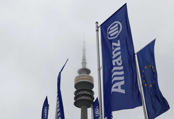 German insurer Allianz flags are seen in front of Munich's radio tower.