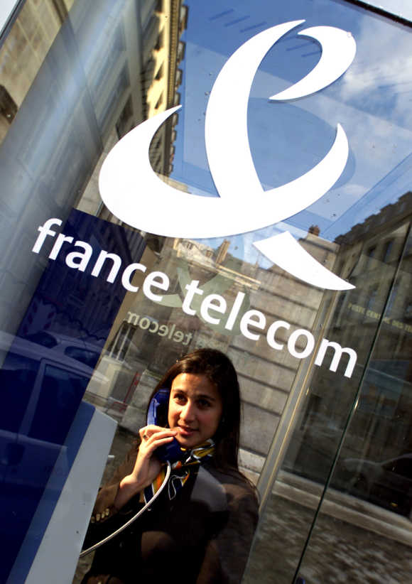 A woman makes a call in a booth in Paris, France.