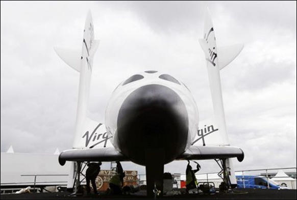 orkers prepare Virgin Galactic's SpaceShipTwo ahead of the Farnborough Airshow 2012.