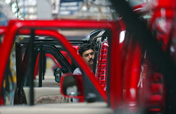 A mechanic works at a Mahindra & Mahindra car factory in Nashik.