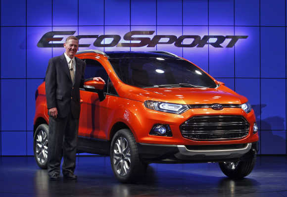 Alan Mulally, President and CEO of Ford Motor, poses next to EcoSport in New Delhi.