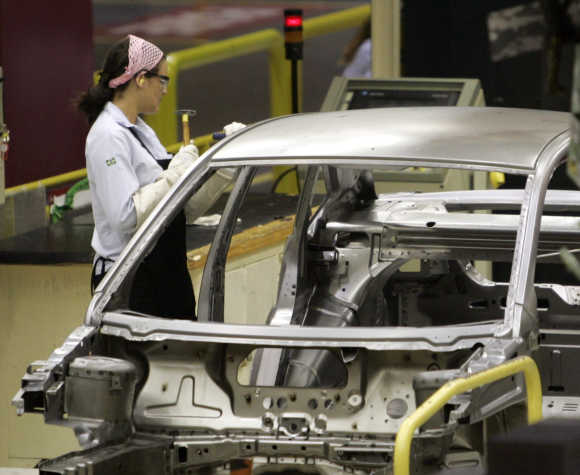 A worker inspects a Ford Ecosport vehicle in Brazilian state of Bahia.