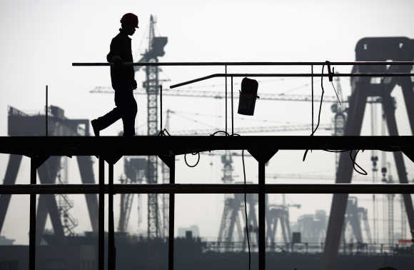 A labourer works at a shipyard in Yueqing City, Zhejiang Province, China.