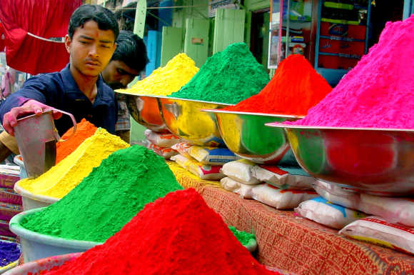 A vendor sells coloured powder on the eve of Holi in Bhopal.