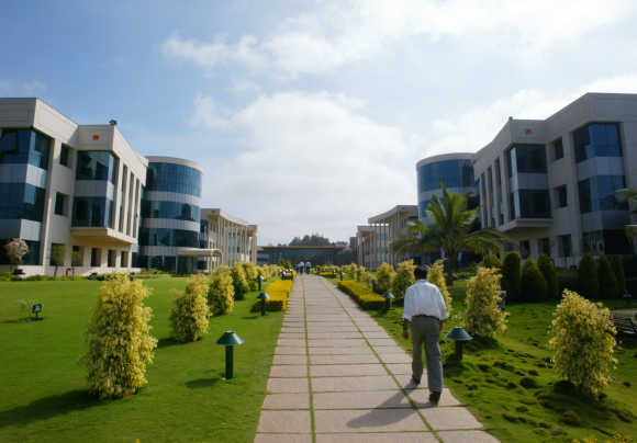 An employee walks at the Infosys campus in Electronics City in Bengaluru.