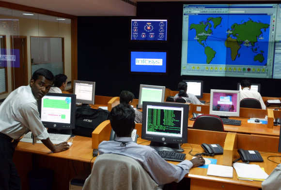 Engineers work in the control room at Infosys campus at Electronics City in Bangalore.